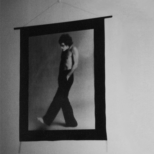 A character (Renowned Australian performing artist, Reg Livermore), downcast, with his hands in his trouser pockets walks downstage toward darkness. Photographer unknown A character (Renowned Australian performing artist, Reg Livermore), downcast, with his hands in his trouser pockets walks downstage toward darkness. Photographer unknown