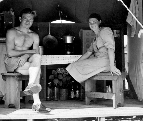 Julius and Agnes Antoniak sitting at a table inside a wooden-floored canvas temporary accommodation tent at Clyde Migrant Camp, Sydney, Australia in 1949. Julius and Agnes Antoniak sitting at a table inside a wooden-floored canvas temporary accommodation tent at Clyde Migrant Camp, Sydney, Australia in 1949.